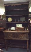 A Georgian oak dresser with single drawer and wavy