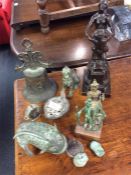A group of Eastern sculptures, bell etc.