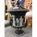 A black Wedgwood urn shaped jardiniere and cover.