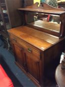 A carved Edwardian walnut two door chiffonier.