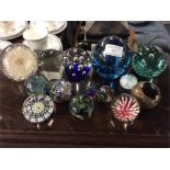 A large group of glass paperweights.