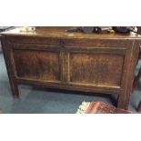 An Antique oak hinged top coffer.