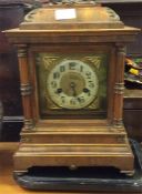 A walnut veneered brass fronted wall clock on stan