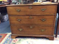 A mahogany three drawer chest on bracket feet with