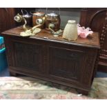 An oak carved front panelled blanket box.