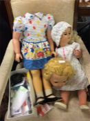 A large old doll together with other examples.