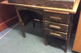 A small three drawer child's oak desk.