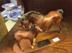 Two Beswick horse on a stand.
