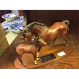 Two Beswick horse on a stand.