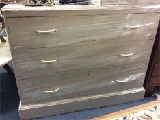 A pine chest of three drawers.