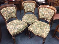A set of three bow back chairs.