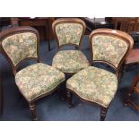A set of three bow back chairs.