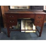 A mahogany four drawer desk on stretcher base.