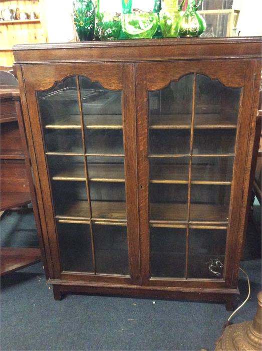 An oak two door cabinet.