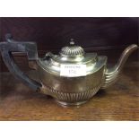 A silver teapot, ingot, etc.