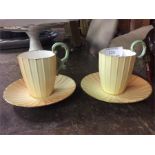 A pair of decorative Royal Worcester coffee cups.