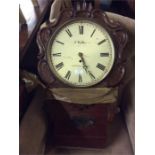 A mahogany wall clock.