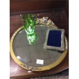 A decorative mirror, glass jug, etc.