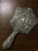 A silver embossed mirror.