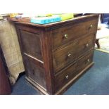 A pine chest of three drawers.