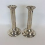 A pair of tall tapering silver candlesticks on circular b