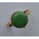 A jade single stone ring in Chinese gold claw moun