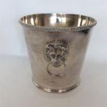 A large plated wine cooler with lion mask handles.