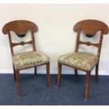 A pair of satinwood hall chairs with ebony decorat
