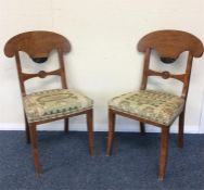 A pair of satinwood hall chairs with ebony decorat