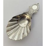 A modern fancy decorated silver caddy spoon with bright c