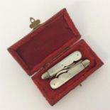 A pair of unusual miniature silver nut picks contained wi