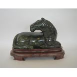 A massive jade figure of a horse in seated positio