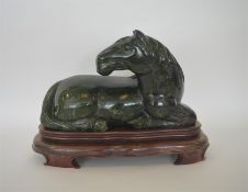 A massive jade figure of a horse in seated positio