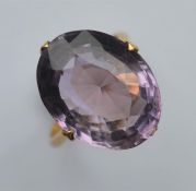 A large amethyst single stone ring in claw mount.
