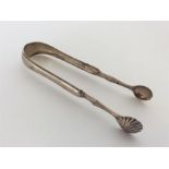 A pair of Scottish silver fancy sugar tongs with fluted b