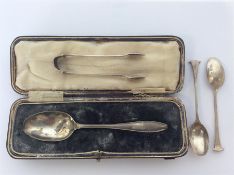A cased silver christening spoon together with tongs etc.