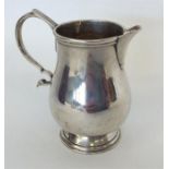 A small silver Sterling cream jug with baluster sh
