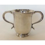 A good George II silver two handled cup on taperin