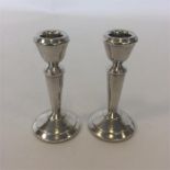 A pair of modern silver tapering piano candlestick