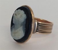 An Antique hard stone cameo ring in reeded mount.