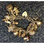 A silver charm bracelet with heart shaped padlock.