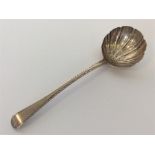 An early Georgian silver ladle with fluted bowl an