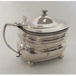 A large Georgian silver mustard with gadroon rim on four