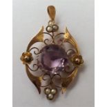 An amethyst and pearl drop pendant with loop top.