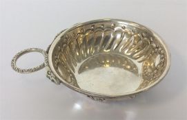 A small snake decorated silver wine taster of typical des