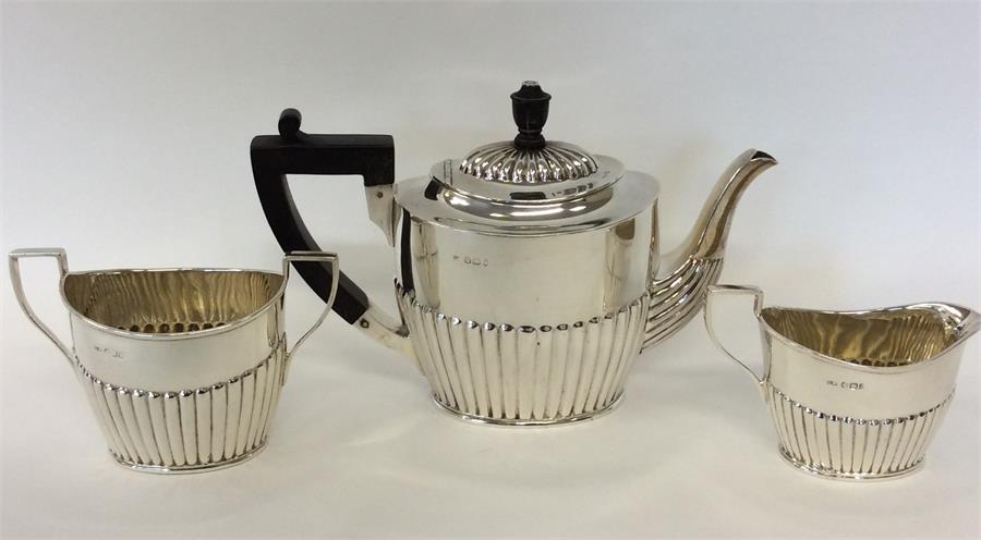 A small bachelor's silver three piece half fluted tea ser