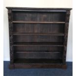 A dark oak bookcase heavily decorated with flowers