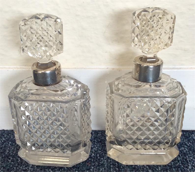 A pair of hobnail cut scent bottles with lift-out