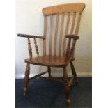 An elm elbow chair. Est. £30 - £40.