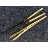 A pair of heavy silver glove stretchers, curling t